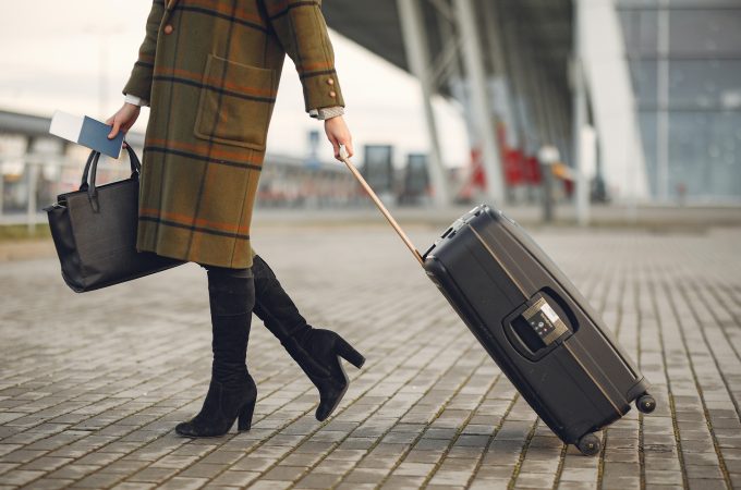 woman pulling suitcase outside