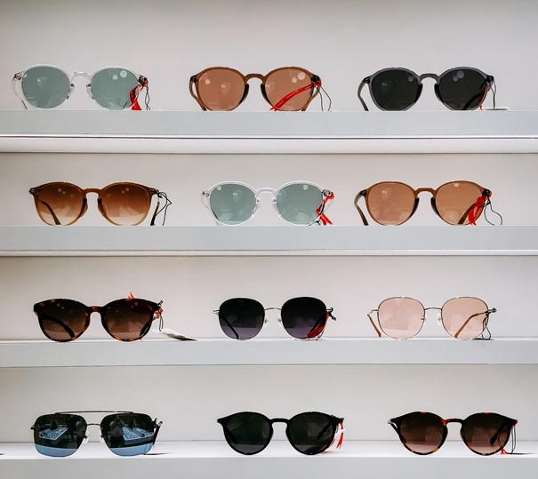 rows of sunglasses on a shelf