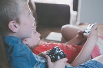 children on couch playing video games